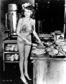cutting pies at the Hollywood Canteen wearing one of her Cover Girl costumes