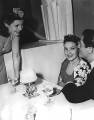 Rita chatting with actress Linda Darnell and Robert Shaw